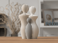Familie skulptur med mor, far og 1 barn i beige og grå ribbemønster på træoverflade – nordisk boligdekoration fra Homae